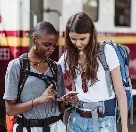 Stylized blue and pink image of a whiskey glass with the wordmark of Vèloce in pink all-caps letters above.
